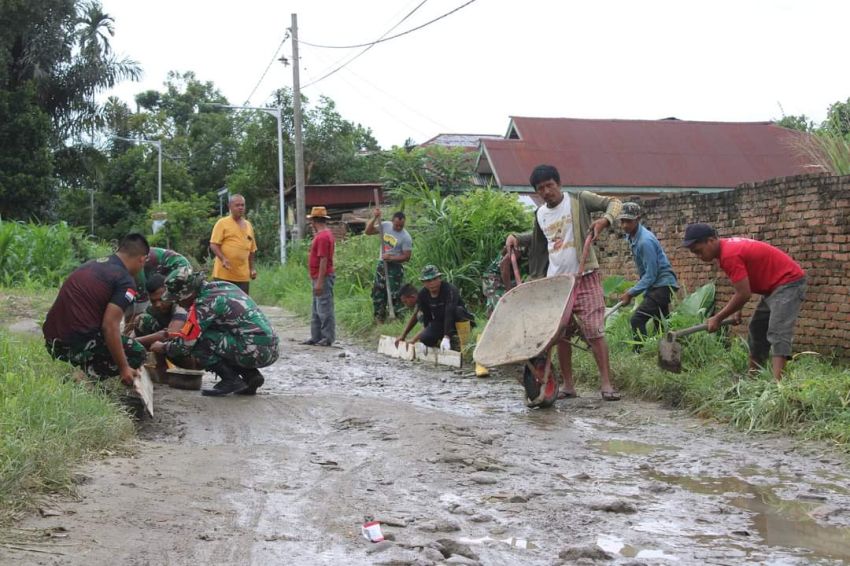 Satgas TMMD ke 122 & Warga Gotong Royong Timbun Jalan Berlubang serta Berlumpur